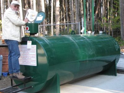 Photo of Graham MacDonald pouring used oil in GIRO's new doudle walled tank.